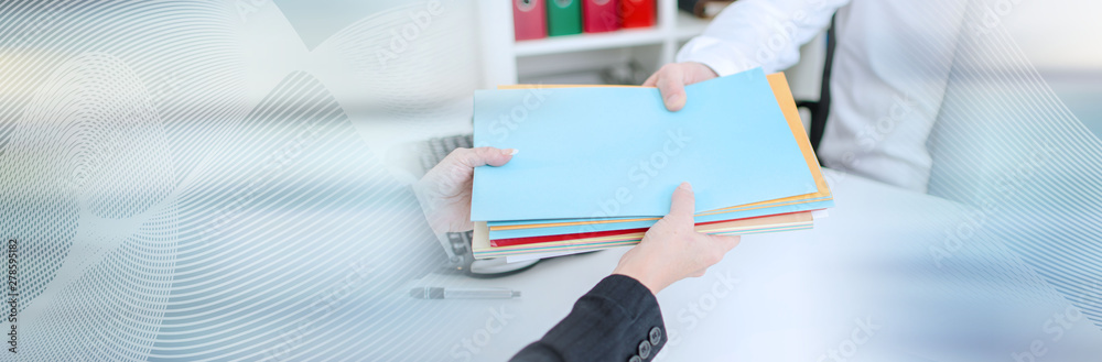 Secretary putting files in the hand of a businessman; panoramic banner - obrazy, fototapety, plakaty 