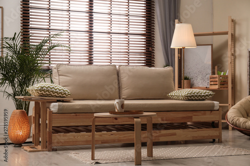 Photos Living room interior with sofa, window blinds and stylish decor elements