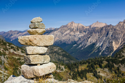 Fotografie Stack of stones rocks trail marker cairn in the mountains, North Cascades National Park, Washington State