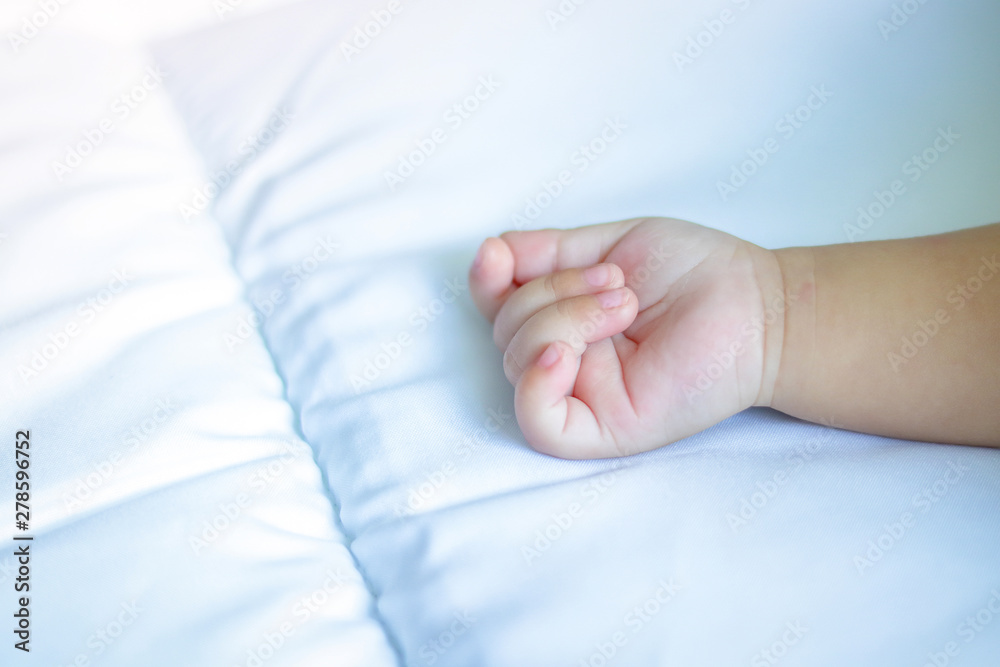 Baby hands on a white mattress have space. Baby hands on a white mattress have space.