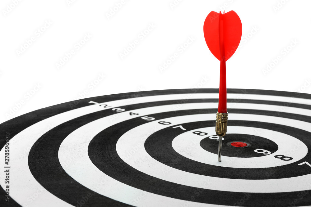 Dart board with color arrow hitting target, closeup