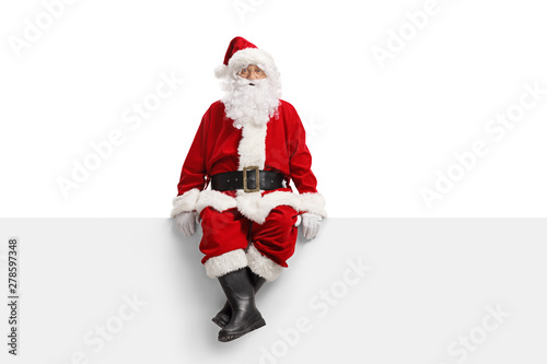 Santa claus sitting on a white banner photo