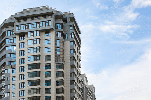 Modern building with tinted windows against sky. Urban architecture