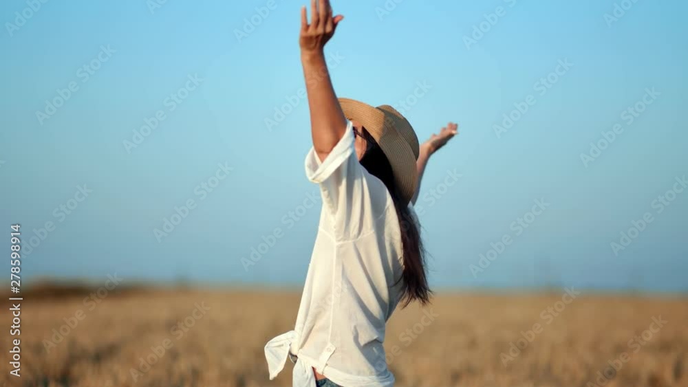 Happy travel female in white shirt rising hand enjoying freedom surrounded by wheat field Happy travel female in white shirt rising hand enjoying freedom surrounded by wheat field