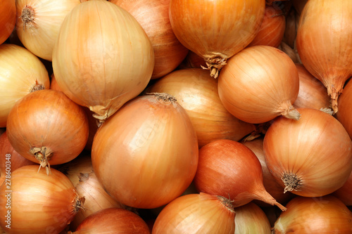 Fresh whole onions as background, top view