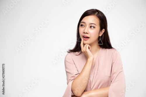 Young Asian lady thinking and looking aside isolated over white background