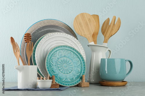 Set of kitchenware on grey marble table near light wall. Modern interior design