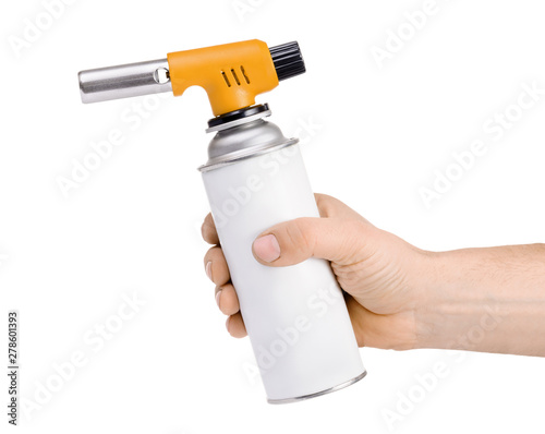 Hand holding manual gas torch burner (blowtorch) isolated on white background. Serie of tools. photo