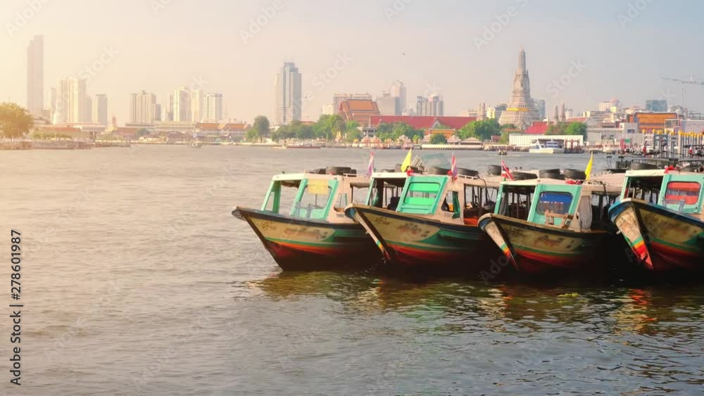 4K Time lapse, Colorful Passenger Boats Docked with Wat Arun at on the Chao Phraya River. 4K Time lapse, Colorful Passenger Boats Docked with Wat Arun at on the Chao Phraya River.