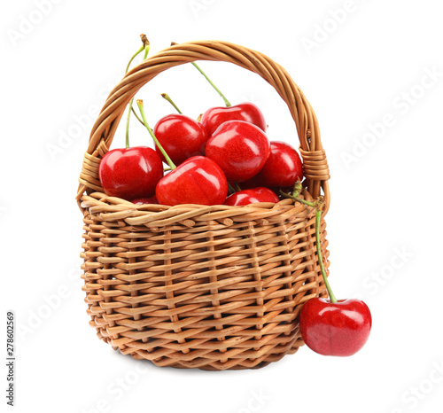 Wicker basket with ripe sweet cherries on white background