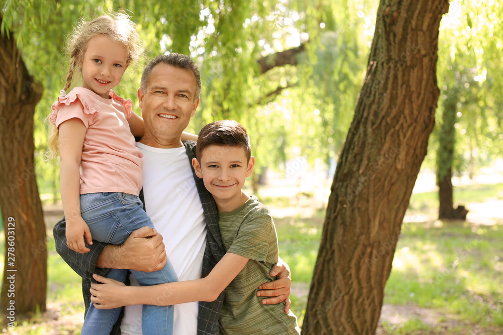 Male pensioner with grandchildren in park. Space for text Male pensioner with grandchildren in park. Space for text