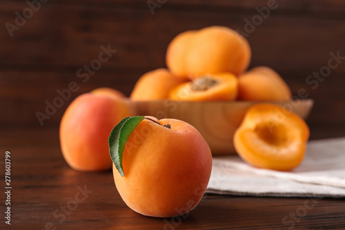 Delicious ripe sweet apricot on wooden table, closeup
