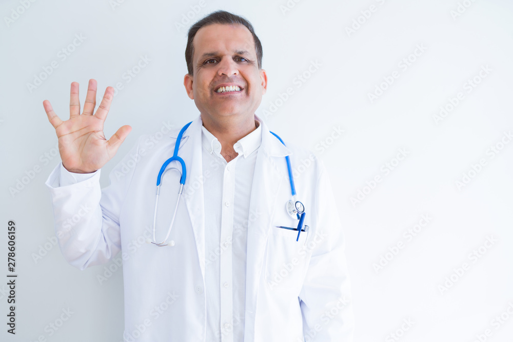 Middle age doctor man wearing stethoscope and medical coat over white background showing and pointing up with fingers number five while smiling confident and happy. Middle age doctor man wearing stethoscope and medical coat over white background showing and pointing up with fingers number five while smiling confident and happy.