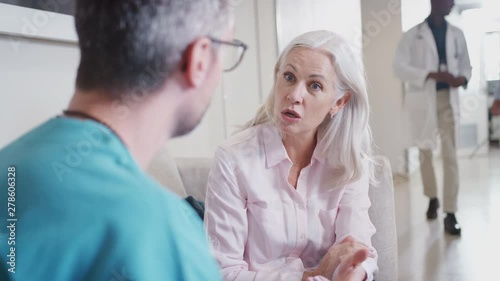 Doctor Welcoming To Senior Female Patient Being Admitted To Hospital photo