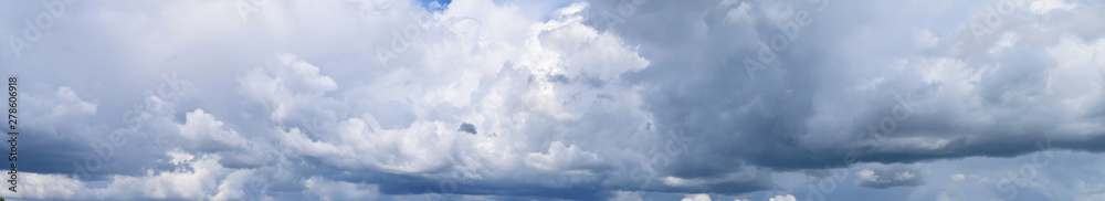 Fototapeta premium Clouds against the blue sky. Atmospheric phenomenon-vaporization, visible to the naked eye, panorama.