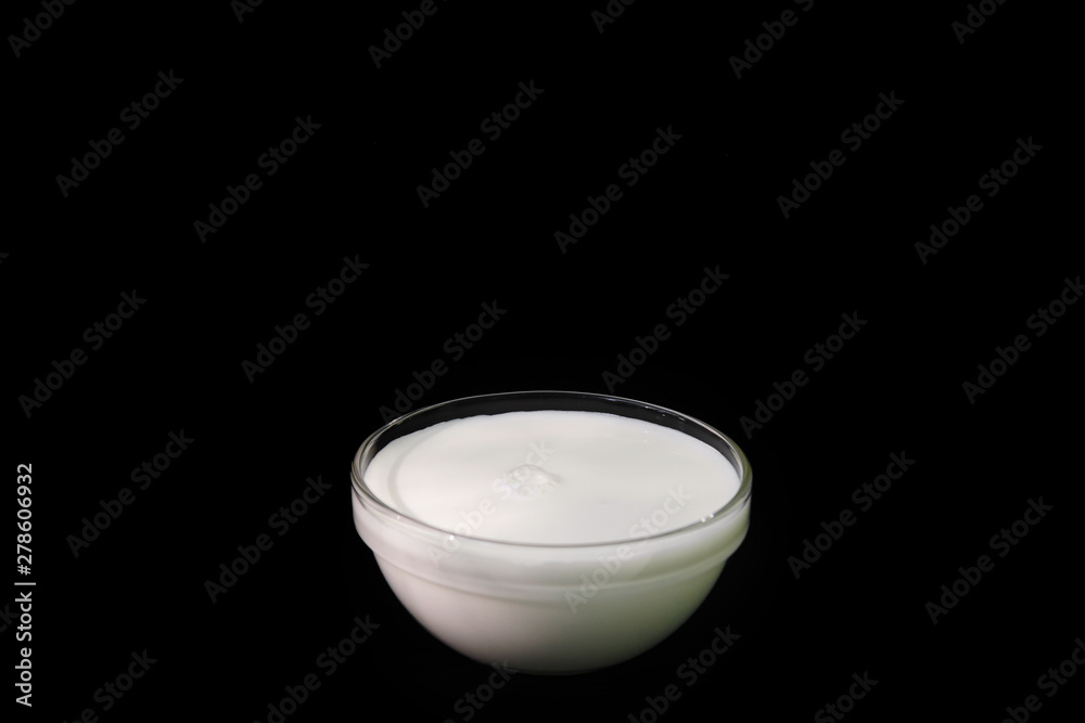 Glass of fresh milk isolated on black background with copy space. Glass of fresh milk isolated on black background with copy space.