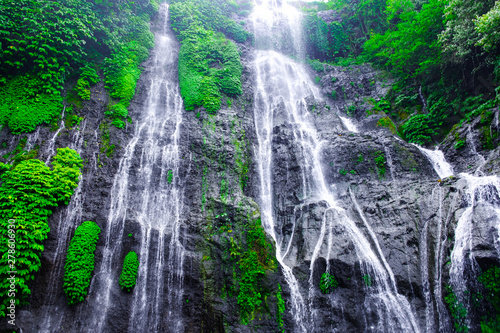 Banyumala waterfall with cascades among the green tropical trees and plants in the North of the island of Bali, Indonesia