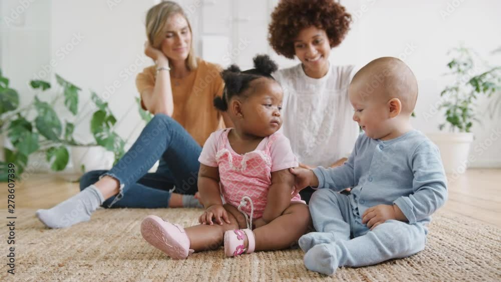 Two Mothers Meeting For Play Date With Babies At Home In Loft Apartment Two Mothers Meeting For Play Date With Babies At Home In Loft Apartment