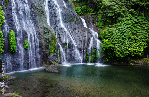 Banyumala waterfall with cascades among the green tropical trees and plants in the North of the island of Bali  Indonesia