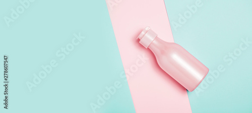 Creative minimal beauty and health background with pink bottle © paninastock