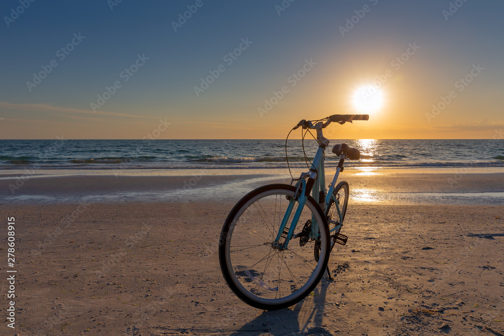 Fototapeta premium Bike on a Beach at Sunset