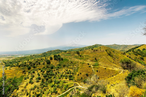 picturasque view on a green and yellow hills with amazing sky photo