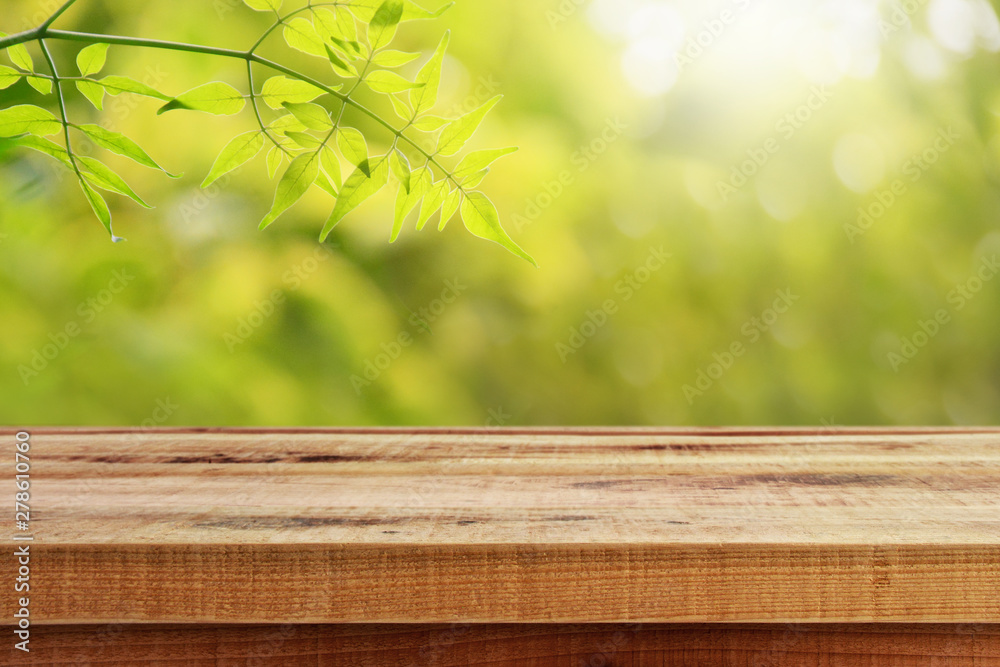 Wooden table and blurred leaf nature in garden background. 
