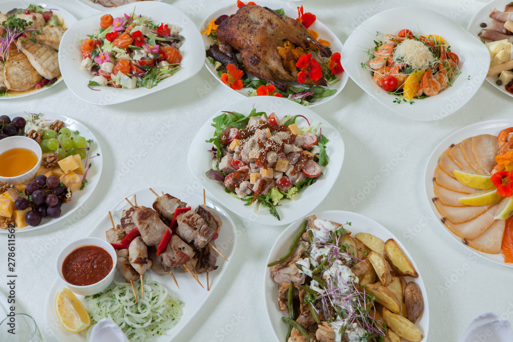 Beautiful festive table served for wedding celebration dinner at home or restaurant interior. Table full of food at a restaurant.  Full round table.