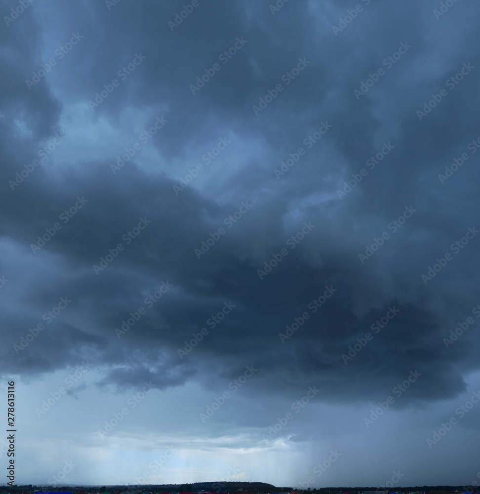 Heavy storm clouds, panorama. Powerful cumulonimbus clouds in front of heavy rain or hail.