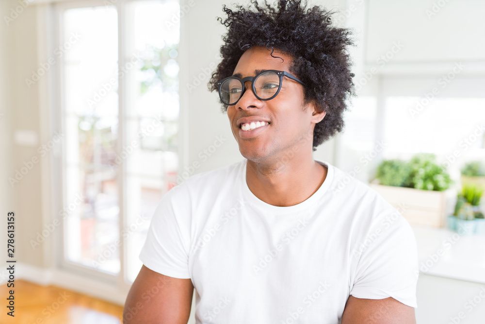 Fototapeta premium African American man wearing glasses smiling looking side and staring away thinking.