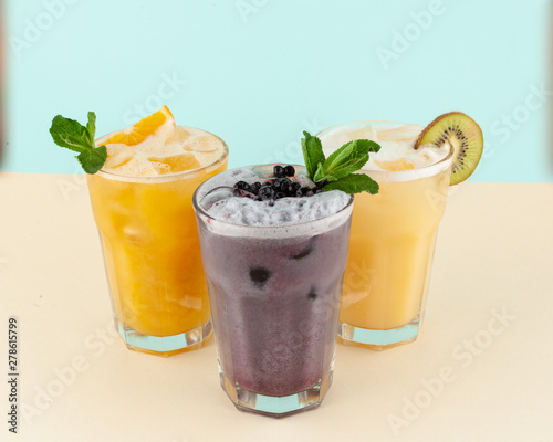 Refreshing fling cocktails with fruit juices, sorbet and soda: blueberry cocktail, orange cocktail and exotic one