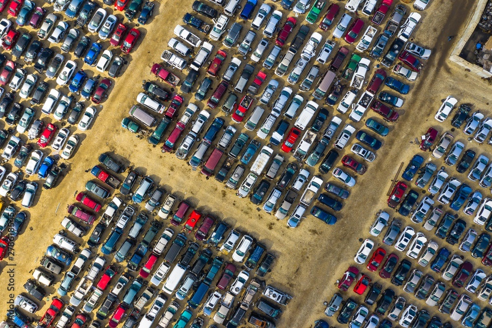 Aerial view of rows of old cars that have served, assembled in a junk yard waiting to be recycled for their reusable parts, Aurora, IL, USA. Aerial view of rows of old cars that have served, assembled in a junk yard waiting to be recycled for their reusable parts, Aurora, IL, USA.