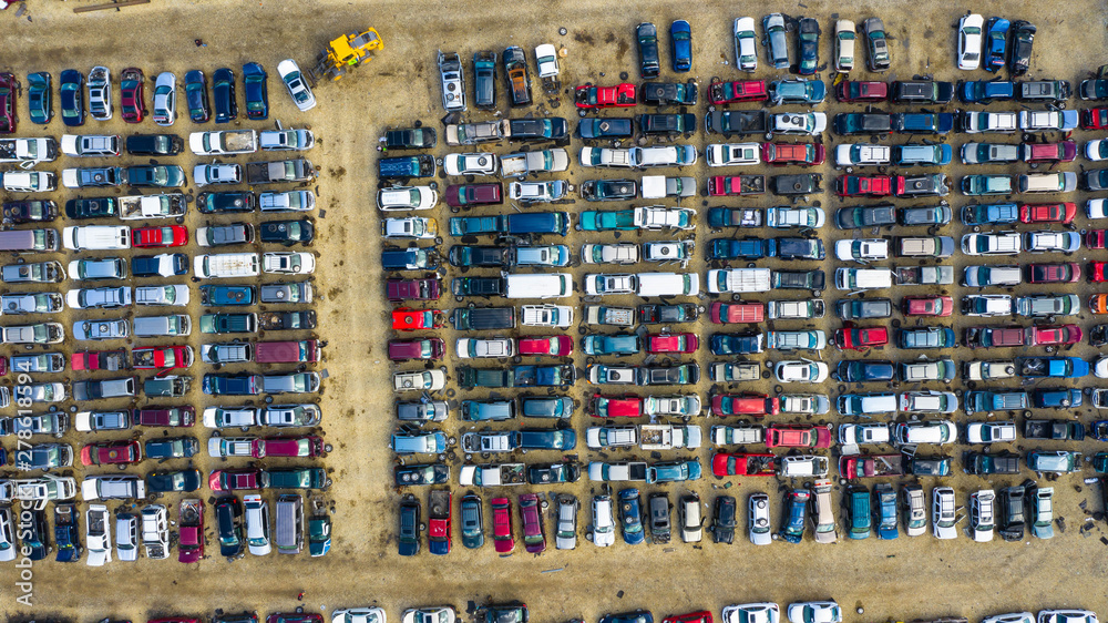 Aerial view of rows of old cars that have served, assembled in a junk yard waiting to be recycled for their reusable parts, Aurora, IL, USA. Aerial view of rows of old cars that have served, assembled in a junk yard waiting to be recycled for their reusable parts, Aurora, IL, USA.