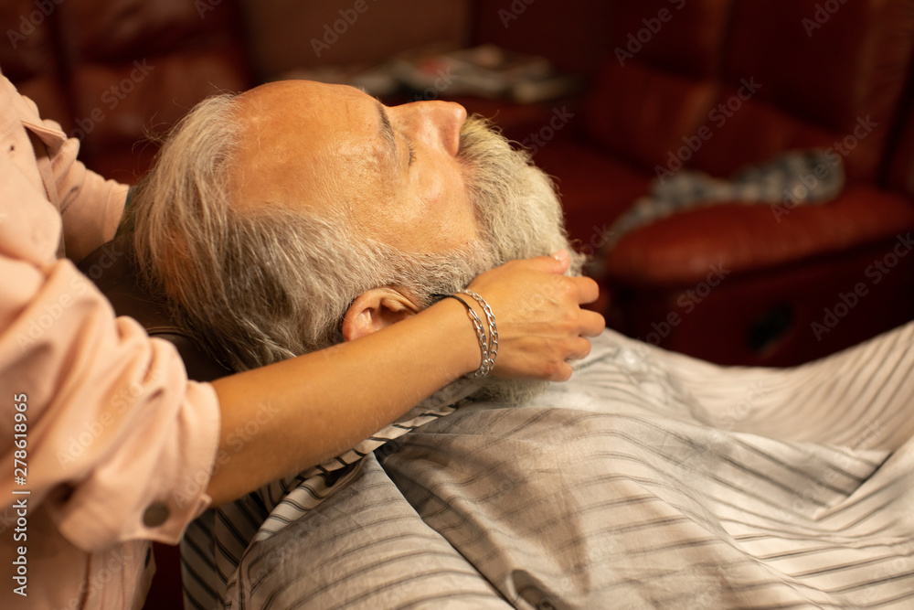 Master makes beards correction in barbershop salon. Close up photo. Master makes beards correction in barbershop salon. Close up photo.