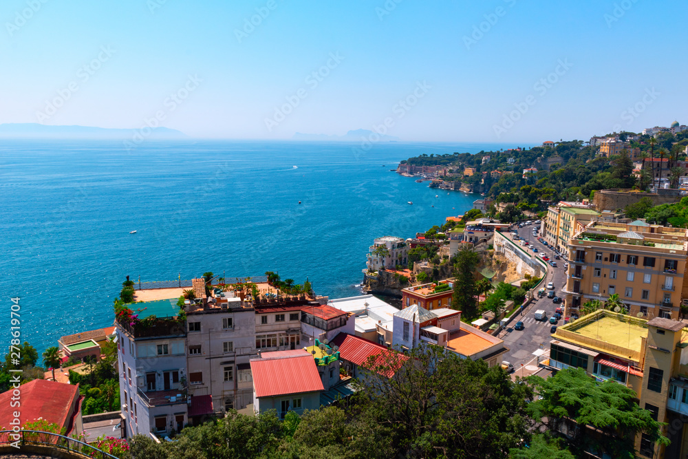 View of the coast of Naples on a clear sunny day. Houses on the shore of the Gulf of Naples. Italy, Europe.