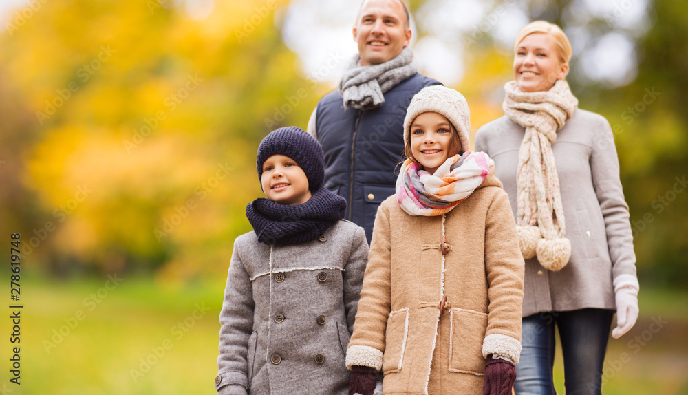 family, childhood, season and people concept - happy family with two kids walking in autumn park