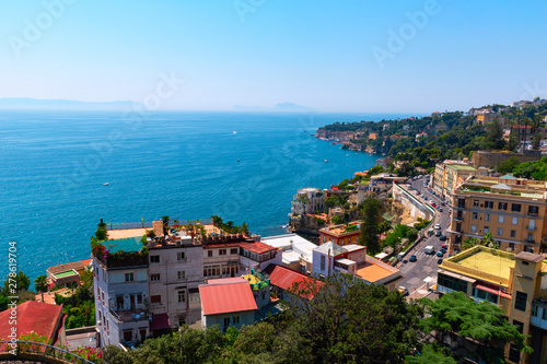 View of the coast of Naples on a clear sunny day. Houses on the shore of the Gulf of Naples. Italy, Europe.