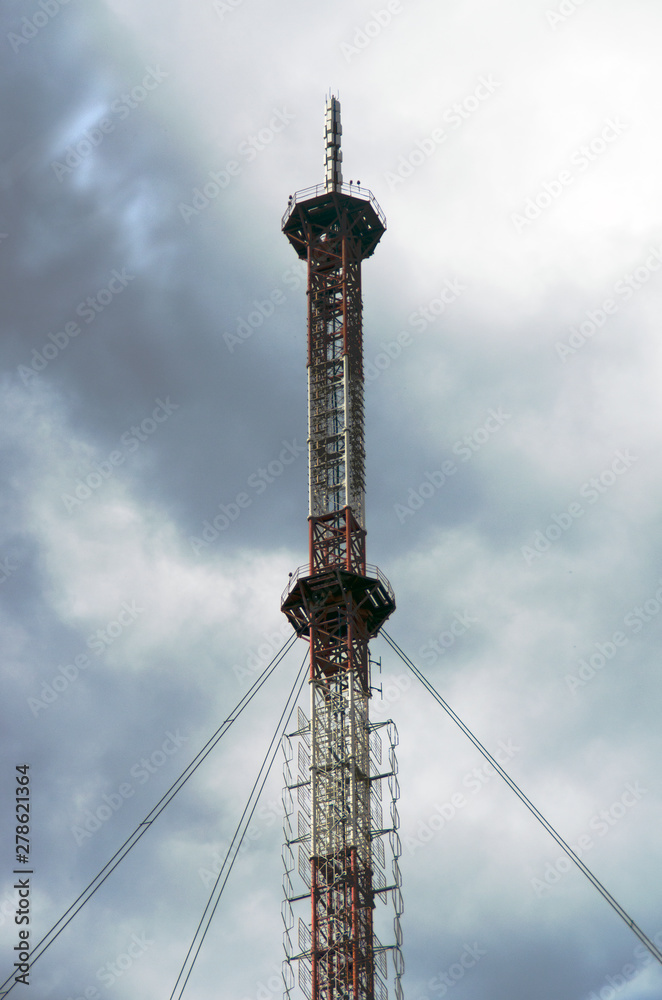 High TV tower on a cloudy sky background. High TV tower on a cloudy sky background.