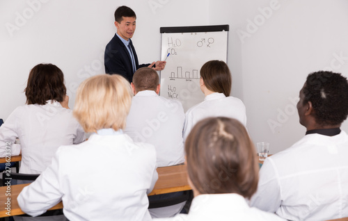 Smiling male giving presentation for medics