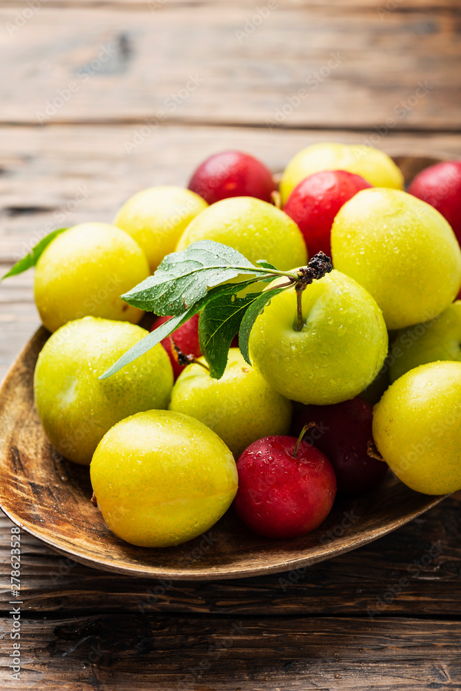 Fresh sweet plums on the wooden table Fresh sweet plums on the wooden table