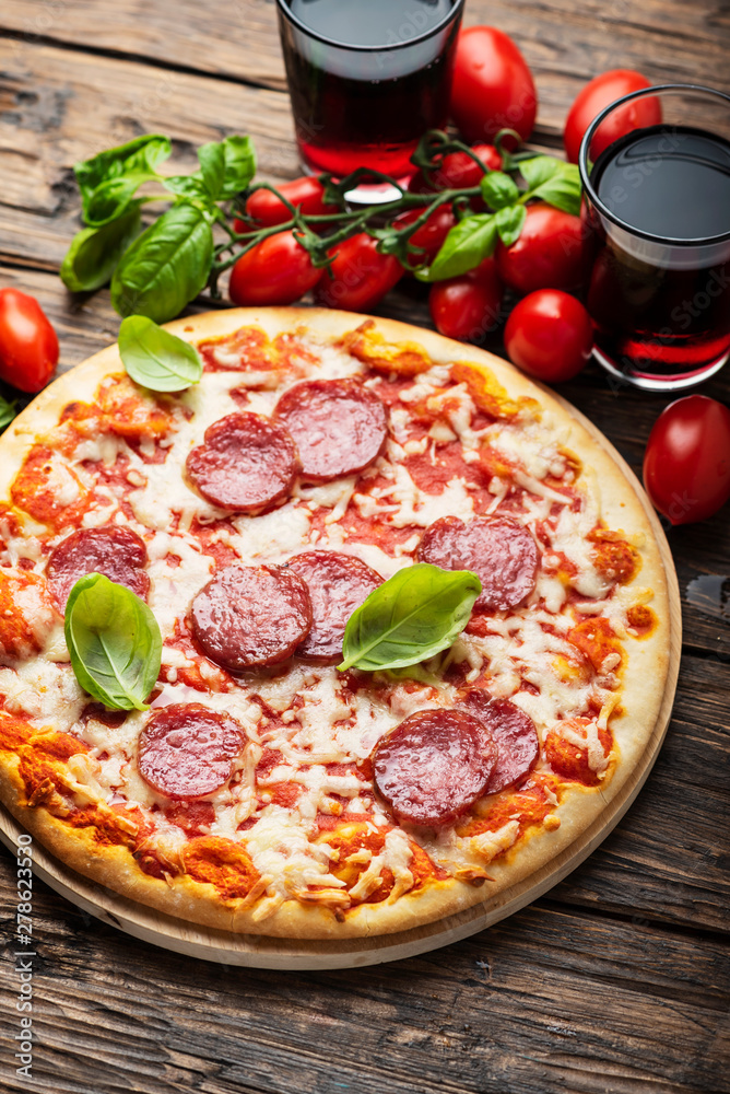 Italian pizza with tomato and salami Italian pizza with tomato and salami