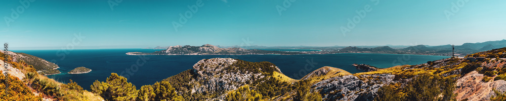The wild north mountain coastline with clouds hanging in the tops and ocean panorama views. Estellencs, Banyalbufar, Serra de Tramuntana, Mallorca, Spain , Balearic Islands