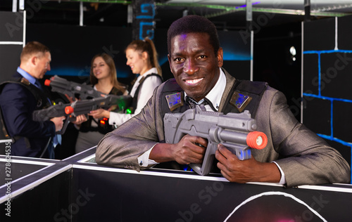 Afro businessman playing laser tag