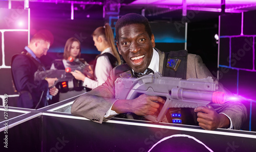 African American with laser gun playing laser tag © JackF