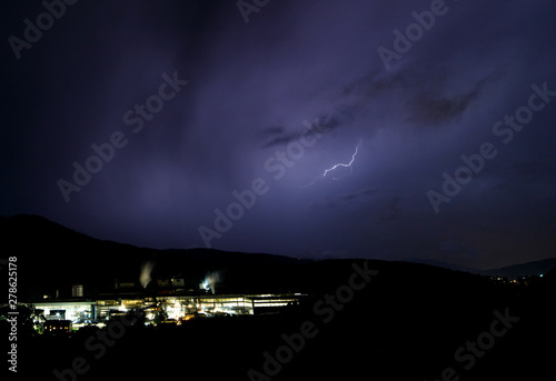 a dangerous storm in a summer night full of lighting bolts with view above the austrian city of leoben to the east photo