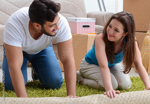 Young family unpacking at new house with boxes