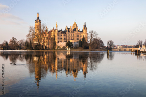 Dawn at Schwerin Palace (Schweriner Schloss), reflected in the water of Schweriner See lake. World Heritage Site in Mecklenburg-Vorpommern, Germany