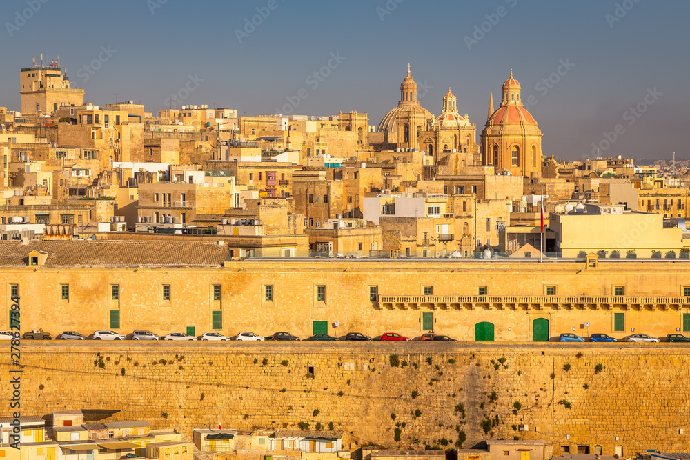 Fototapeta premium Valletta from the Ship. Exposure of Valletta, Malta, taken at Sunrise from a ship while arriving at this beautiful fortified city.