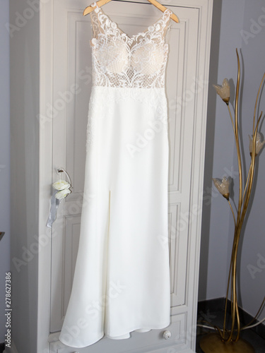 White modern wedding dress on a hanger