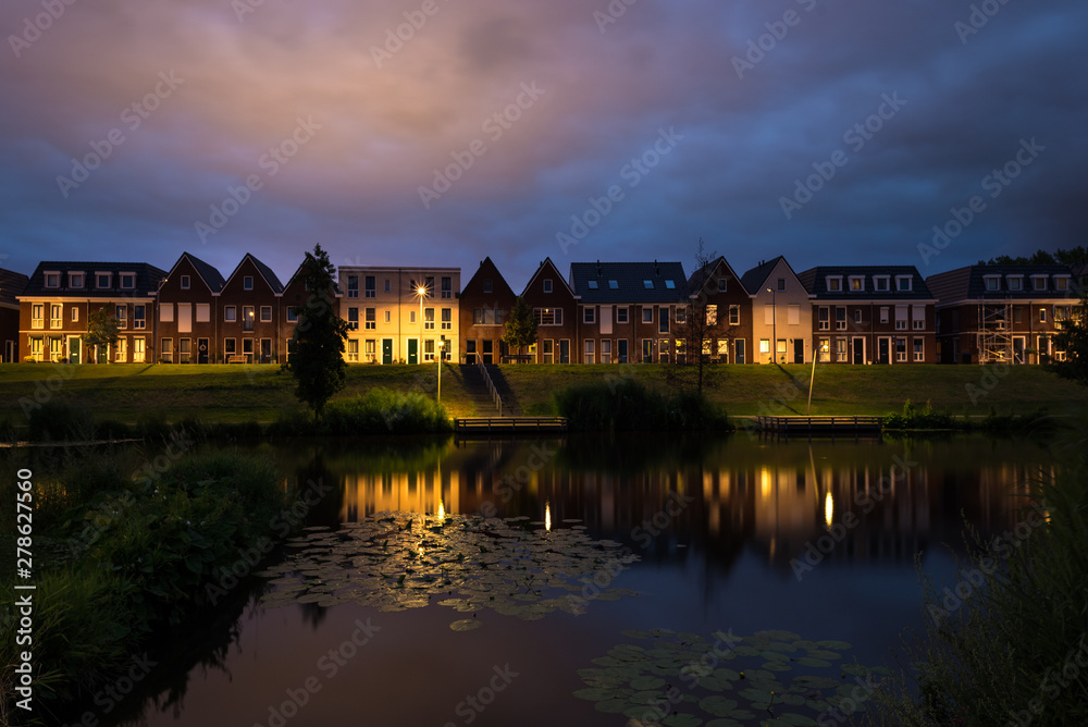 Modern architecture in classical dutch style along the waterside in a town in The Netherlands Modern architecture in classical dutch style along the waterside in a town in The Netherlands